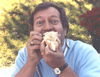 A humorous picture of Ron Pettus eating a hot dog.