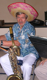 A picture of Ron Pettus, wearing a sombrero, with his baritone saxophone.